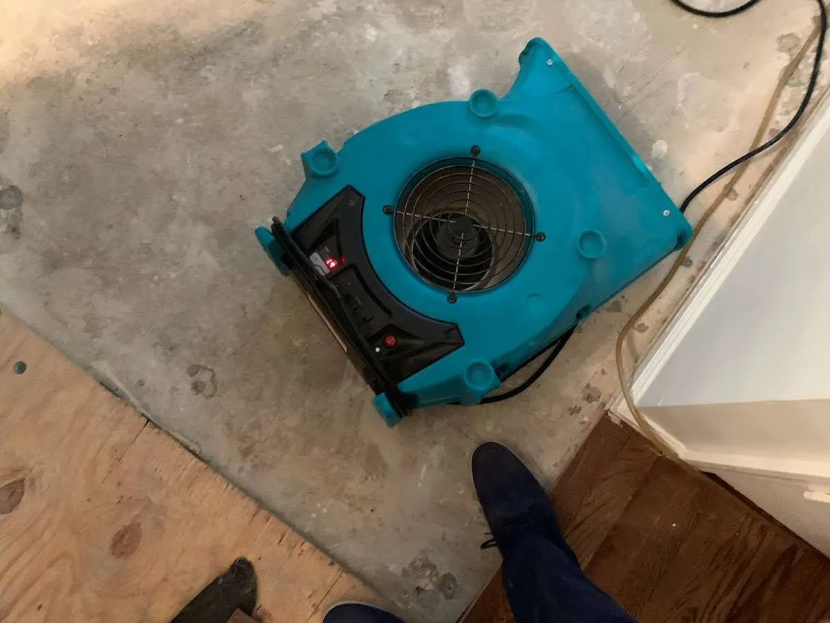 Air mover drying subfloor during Commercial Water Damage Restoration in Wethersfield